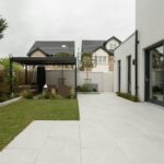 a house with a large yard and a covered patio